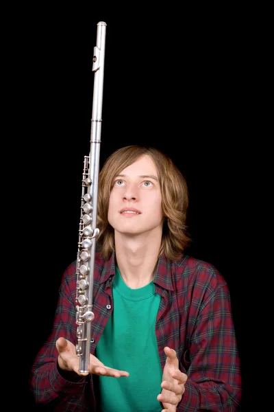 The young man plays with a flute — Stock Photo, Image