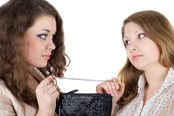 Two beautiful girls and one handbag. Iso — Stock Photo, Image