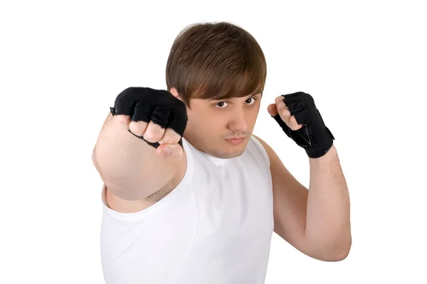 Young man throwing a punch. Isolated on — Stock Photo, Image