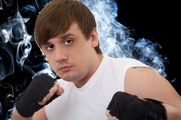 Portrait of the young fighter in a smoke — Stock Photo, Image