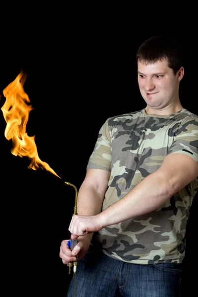 Crazy young man with a gas torch — Stock Photo, Image