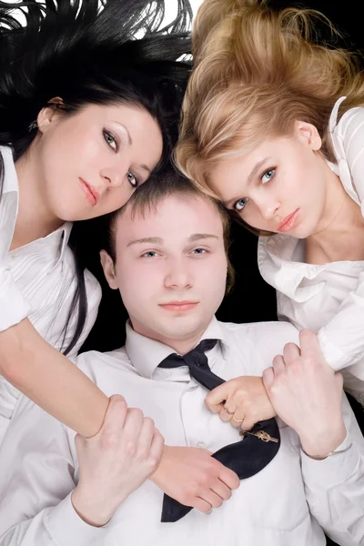 Portrait if the young man and two pretty Royalty Free Stock Photos