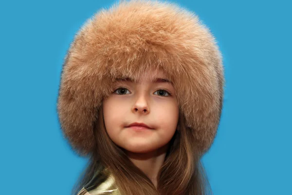 Girl in a fluffy cap from natural fur. — Stock Photo, Image