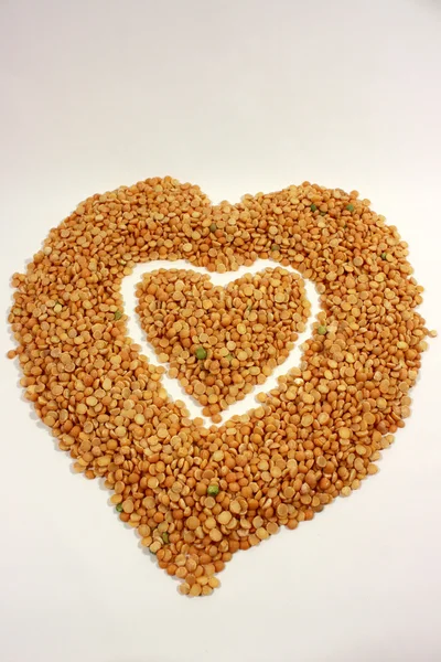 Heart from the groats of pea. — Stock Photo, Image