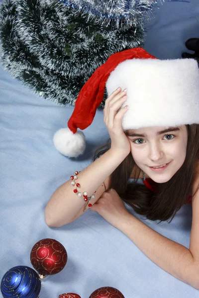Girl in a cap with the Christmas symbols — Stock Photo, Image