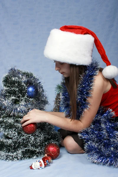 Girl in a cap with the Christmas symbols — Stock Photo, Image