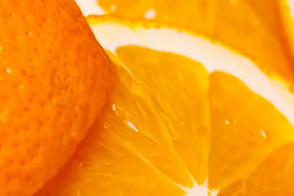Juicy parts of orange and skin. — Stock Photo, Image