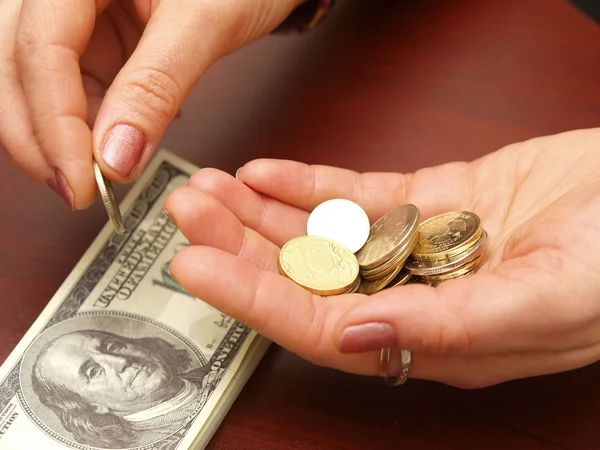 Female hands recalculate small coins aga — Stock Photo, Image