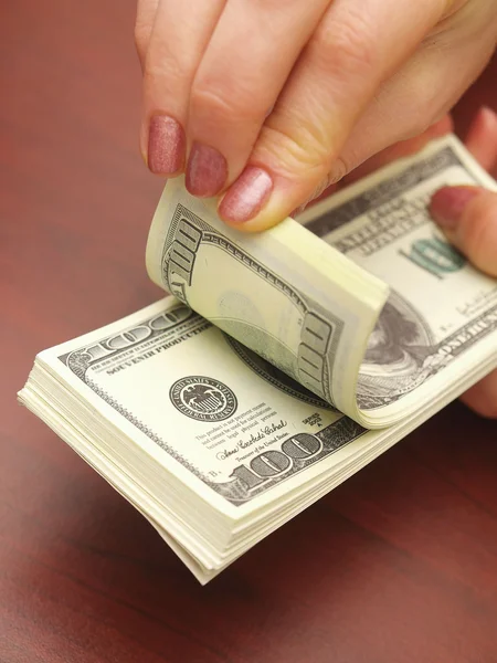 Female hands consider dollars — Stock Photo, Image