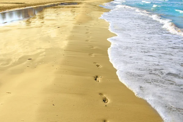 Voetafdrukken en reflectie op het zand — Stockfoto
