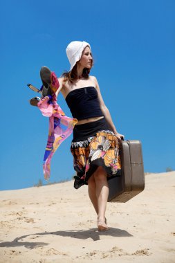 Beautiful girl is walking on a sand clipart