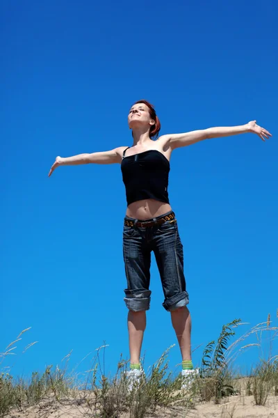 Chica saltando sobre un fondo de cielo azul —  Fotos de Stock