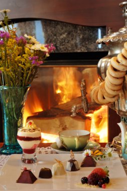 Tea drinking at a fireplace clipart