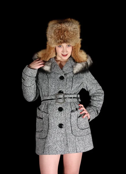 Gilr in coat and fox cap on black backgr — Stock Photo, Image