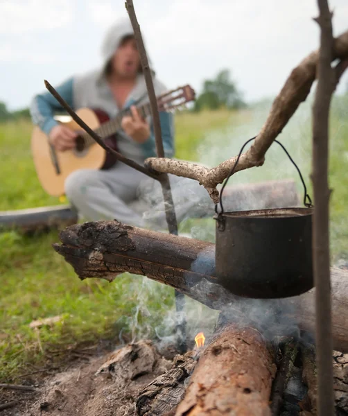 Cooking fresh food in cauldron at camp o — Stok fotoğraf