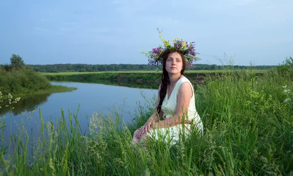Pretty girl in flower chaplet against r — Stock Photo, Image