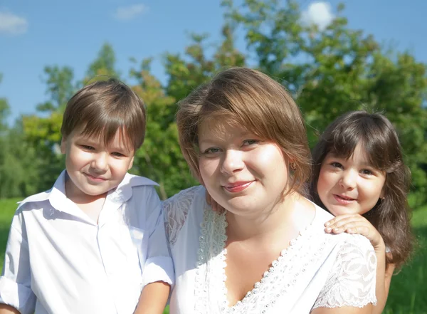 Mother with children on meadow — Stock Photo, Image