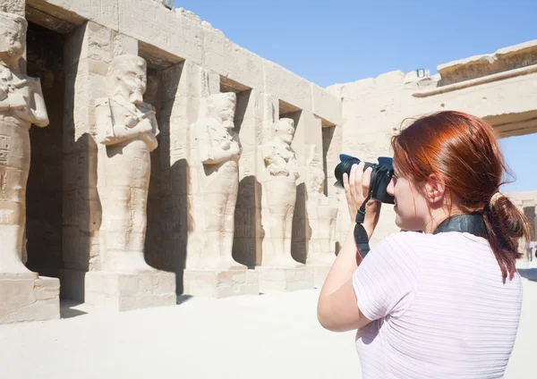 Девушка фотографирует древние статуи — стоковое фото