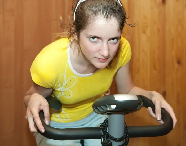 Girl on exercycle — Stock Photo, Image