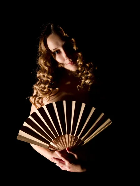 Girl with a fan on black. — Stock Photo, Image