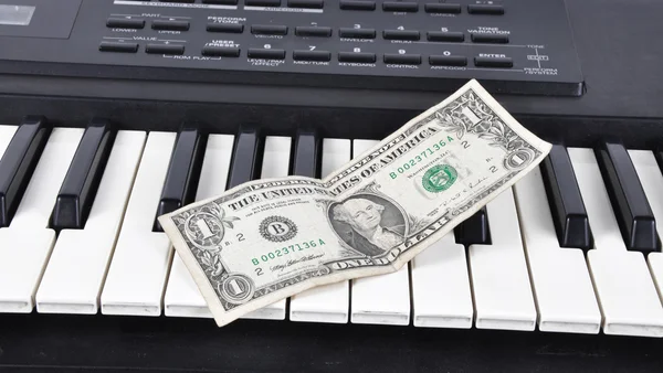 Dolar on an old synthesizer — Stock Photo, Image