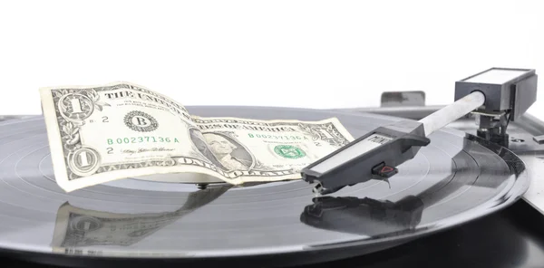 A dollar lying on an old record player — Stock Photo, Image