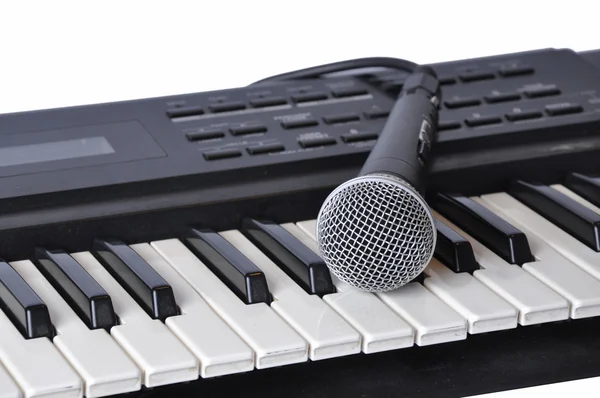 A microphone lying on the keys — Stock Photo, Image