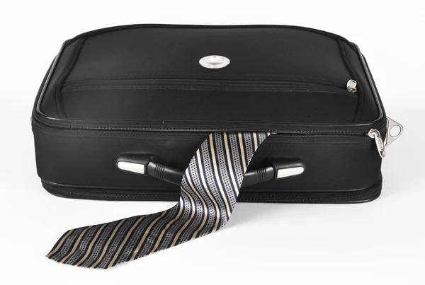 Resväska med en sticker ut slips — Stockfoto