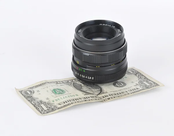 Old lens and dollar — Stock Photo, Image