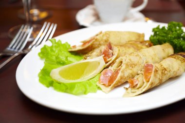 Pancakes with a salmon on a plate clipart