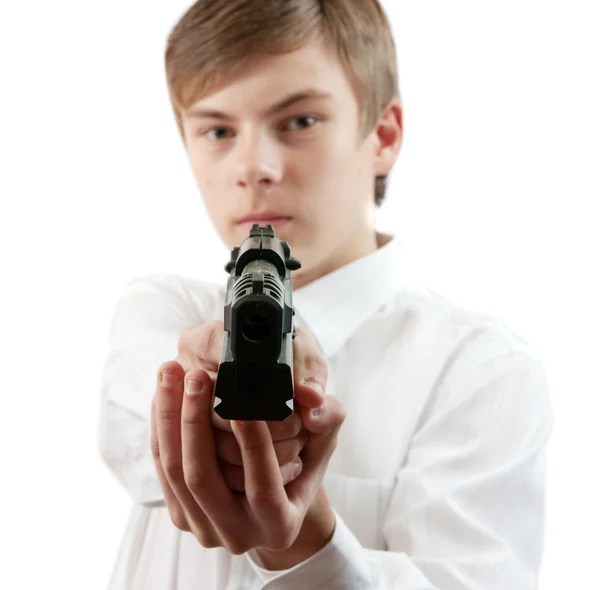 Ung man siktar en svart pistol — Stockfoto