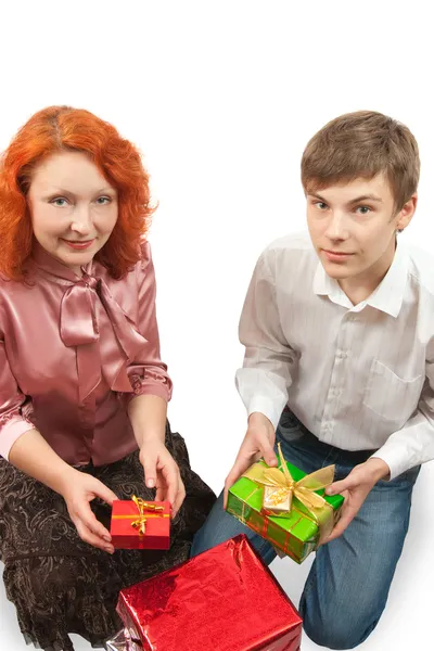 Adult women and teen boy giving gifts — Stock Photo, Image