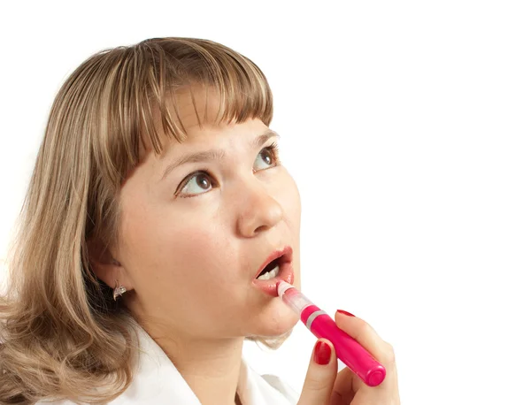Chica aplicando lápiz labial sobre blanco —  Fotos de Stock