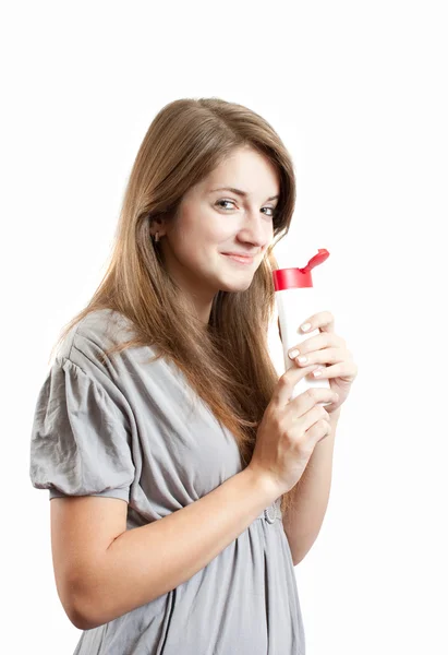Menina sorridente com recipiente cosmético — Fotografia de Stock