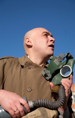 Men with gas mask over blue sky clipart