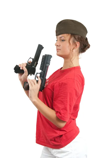 Woman posing in garrison cap with guns — Stock Photo, Image