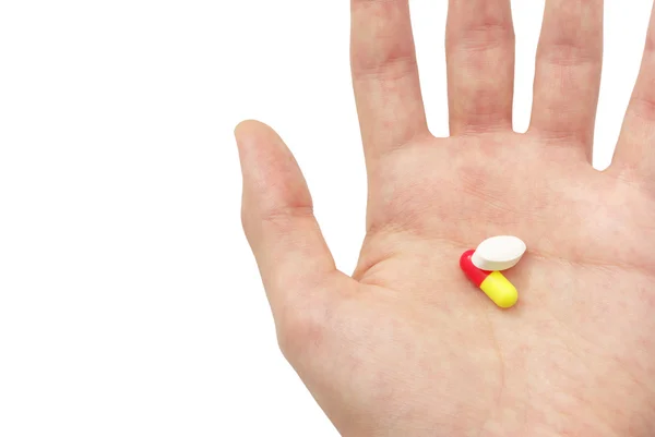 Due pillole sul palmo della mano — Foto Stock