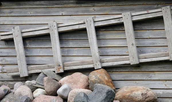 stock image Ladder, stones and wooden wall