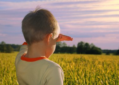 Happy young boy looking horizon in sundo clipart