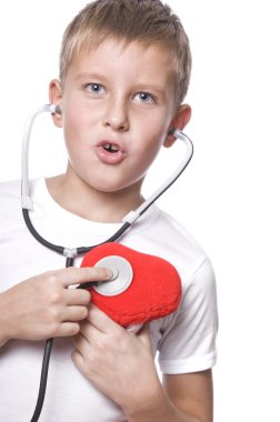 Cute young boy playing doctor clipart