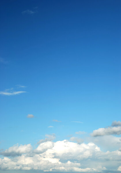 Fluffy cloud on bright blue sky on sun day