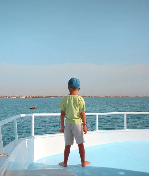 Kleiner Junge beobachtet Horizont auf Segelboot — Stockfoto