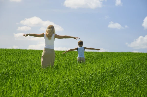 Ma and son walk in field. agricultural n — Stock Photo, Image