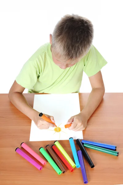 Хлопчик за столом малює сонце — стокове фото
