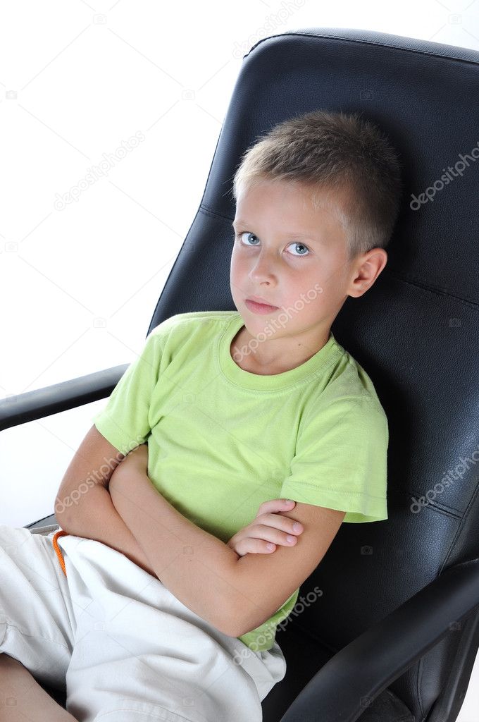 Boy sit on chair and look at camera