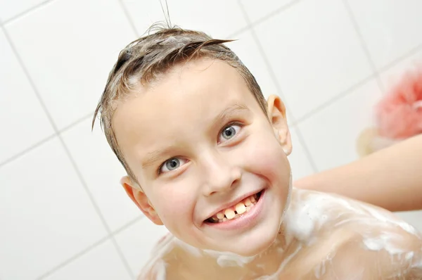 Glücklicher Junge badet in einem Badezimmer — Stockfoto