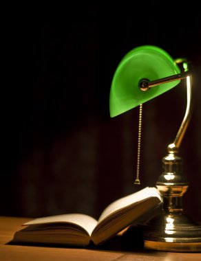 Electric green table lamp and book clipart