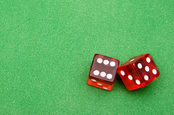 stock image Red dice against green background