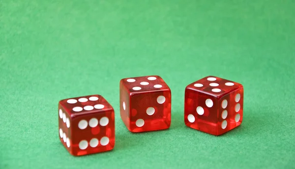 Row of dice on green background — Stock Photo, Image