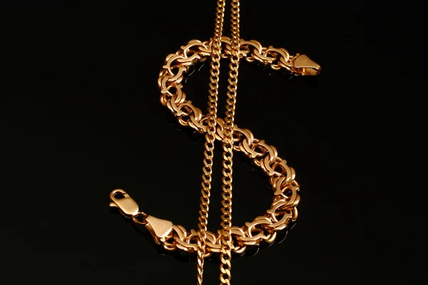 A gold bracelet and a chain — Stock Photo, Image